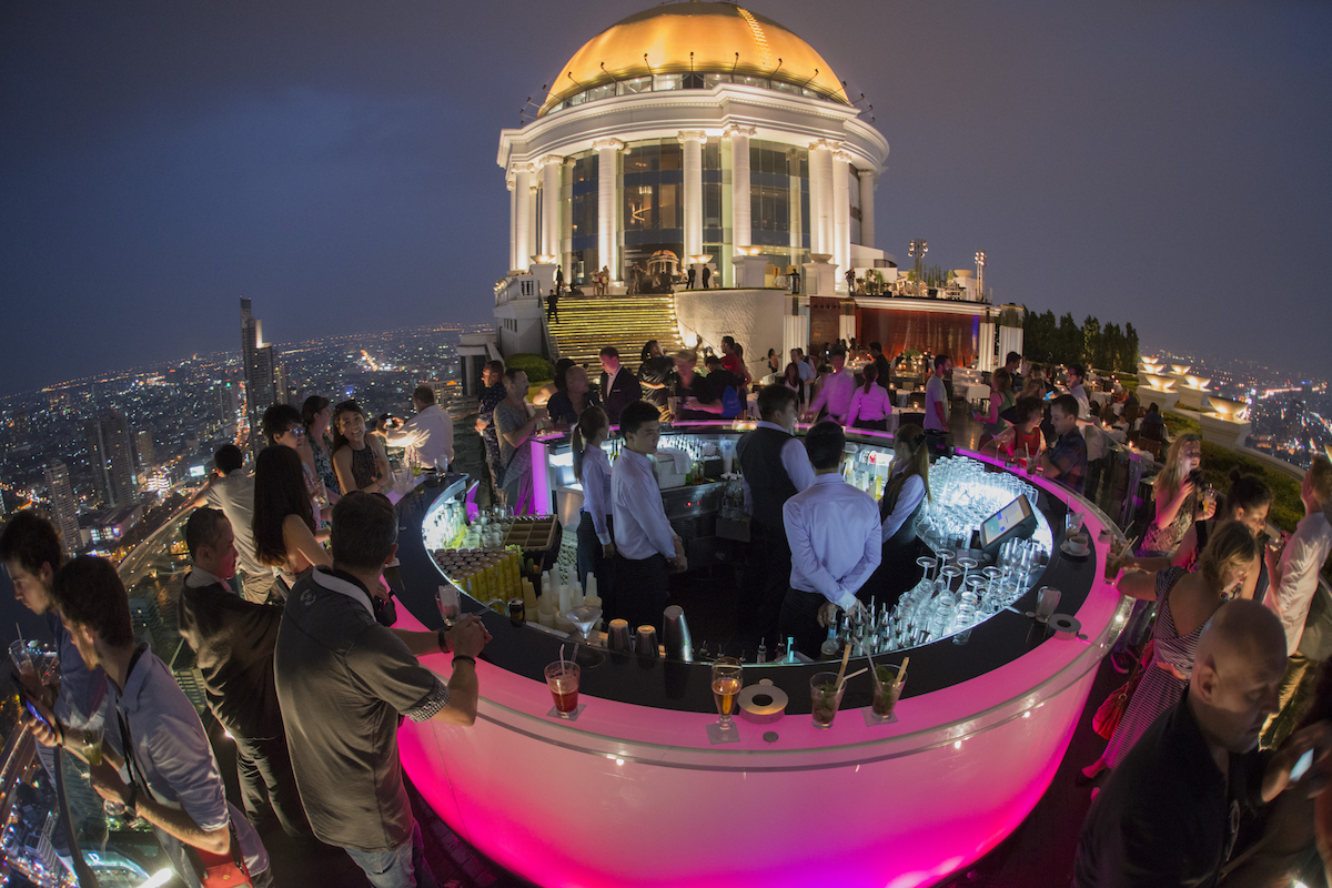Cost of Living in Bangkok (& The Lies That Bloggers Tell) | Sky Bar Bangkok The famous pink Sky Bar at the Riverside Area in the city of Bangkok in Thailand, busy with staff and customers