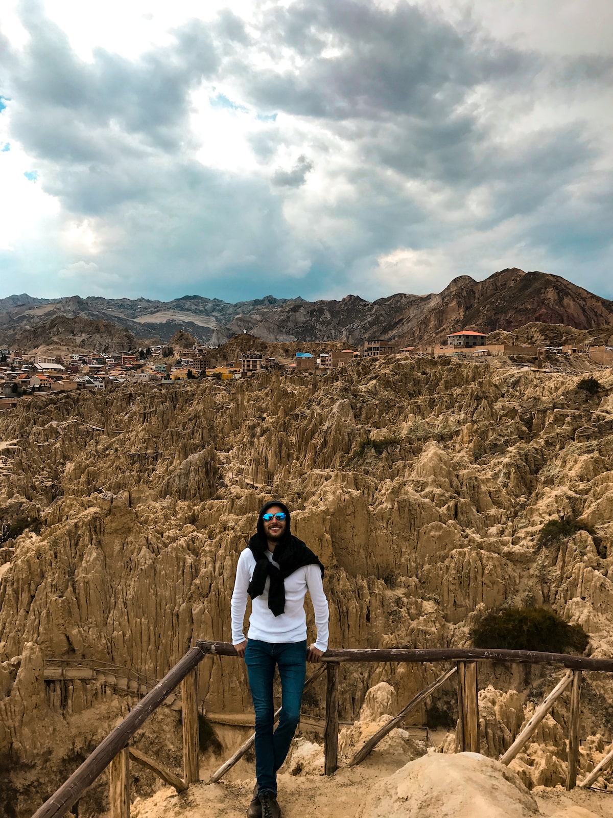 28 Best Things To Do in La Paz, Bolivia & Surrounding Areas | Valley of the Moon La Paz Bolivia A man in sunglasses smiles in a white t-shirt in front of rock formations in La Paz, Bolivia.
