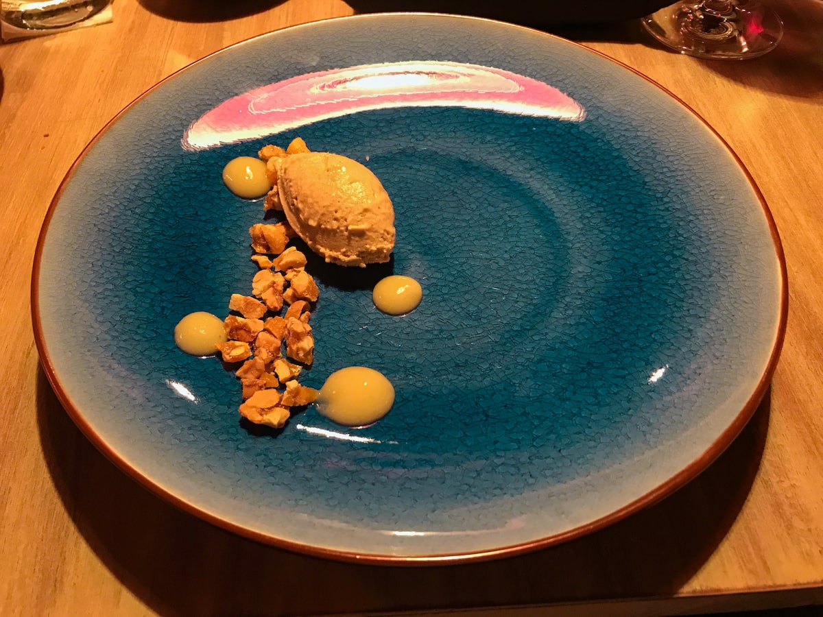 28 Best Things To Do in La Paz, Bolivia & Surrounding Areas | Vegan ice cream Ali Pacha A small scoop of ice cream on a blue plate with honeycomb pieces.