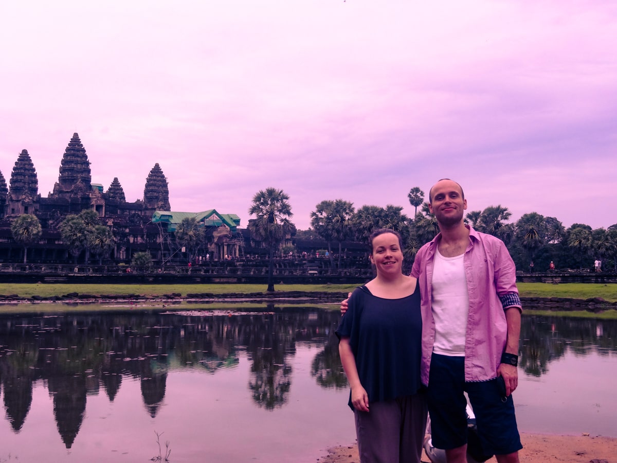 Visiting Angkor Wat: How To Avoid The Crowds | Visiting Angkor Wat A man and a woman pose at sunrise while visiting the Angkor Wat Temple in Cambodia