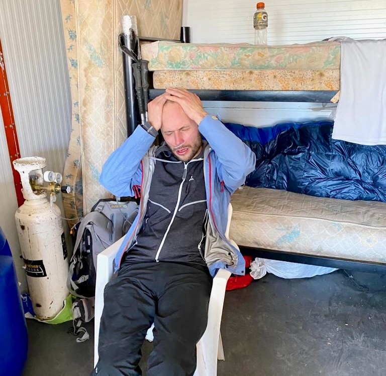 The Only Road Trip Packing List You'll Ever Need! | accident while travelling A man holds his head in agony as he receives oxygen from a tank after a mountain accident
