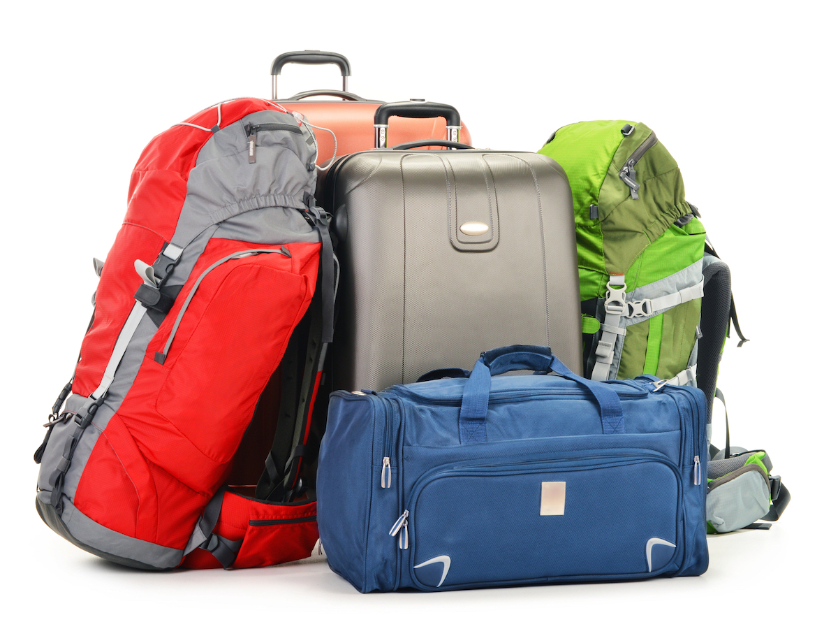 Backpack vs Suitcase Pros & Cons: The Great Travel Battle | backpack vs suitcase Backpacks and suitcases lying next to one another