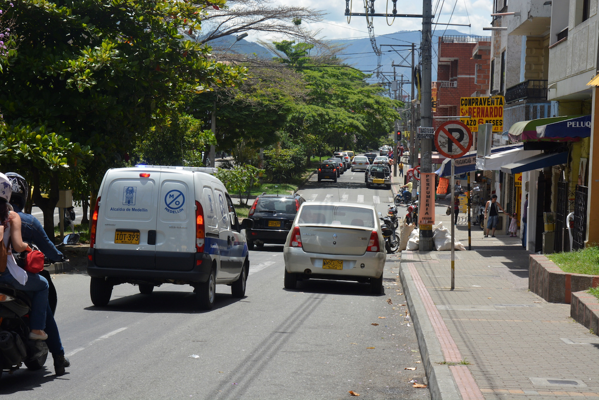 Where To Stay in Medellin: 7 Best Neighbourhoods! | belen medellin Cars driving down the road with trees on the sidewalk in Belen, Medellin.