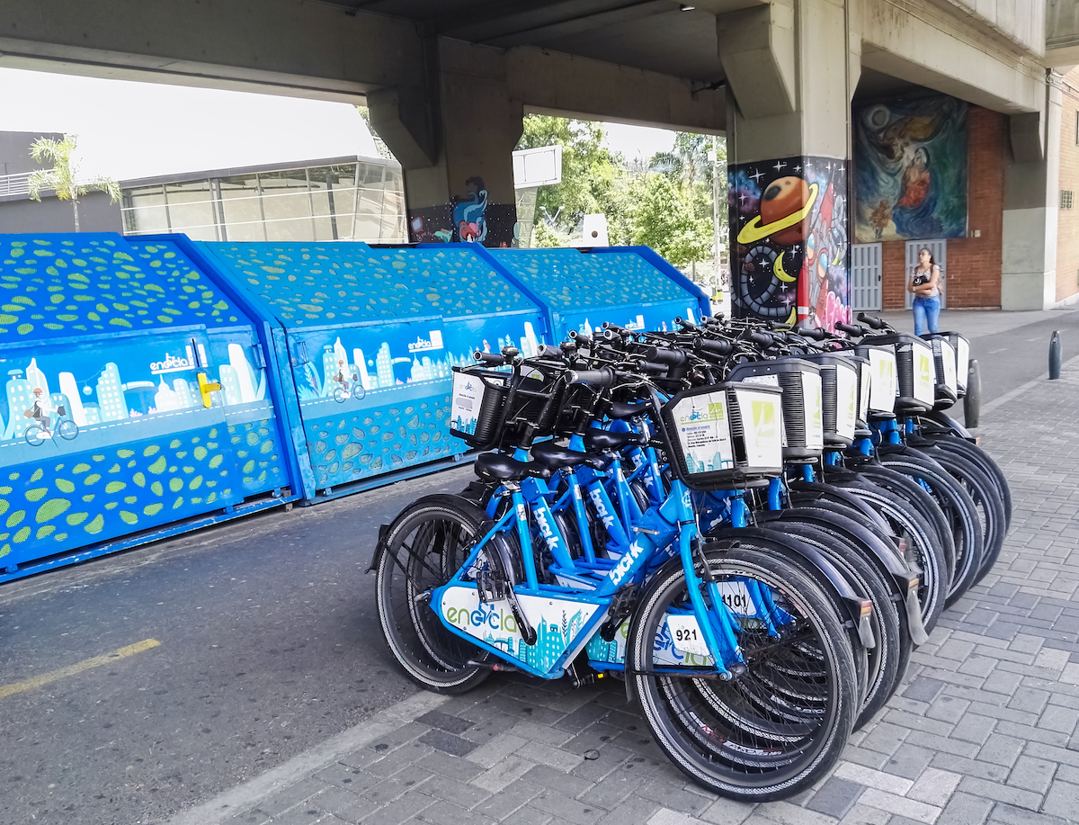 Public Transport in Medellin, Colombia: How To Get Around | bicycles medellin A large volume of blue bicycles parked up alongside each other.