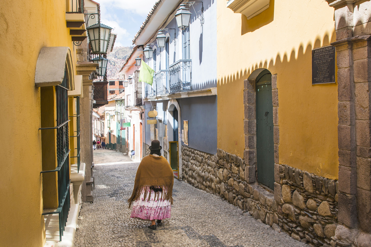 28 Best Things To Do in La Paz, Bolivia & Surrounding Areas | calle jaen colonial Jaen Street in La Paz, Bolivia city centre on a bright summer day. Cholita walking down the street