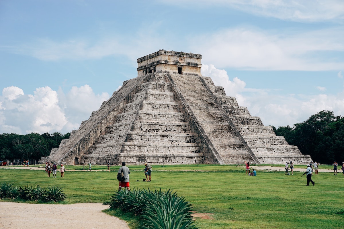 Detailed Digital Nomad Mexico City Guide For 2024 | chichen itza A grey pyramid on the grass during the day in Mexico