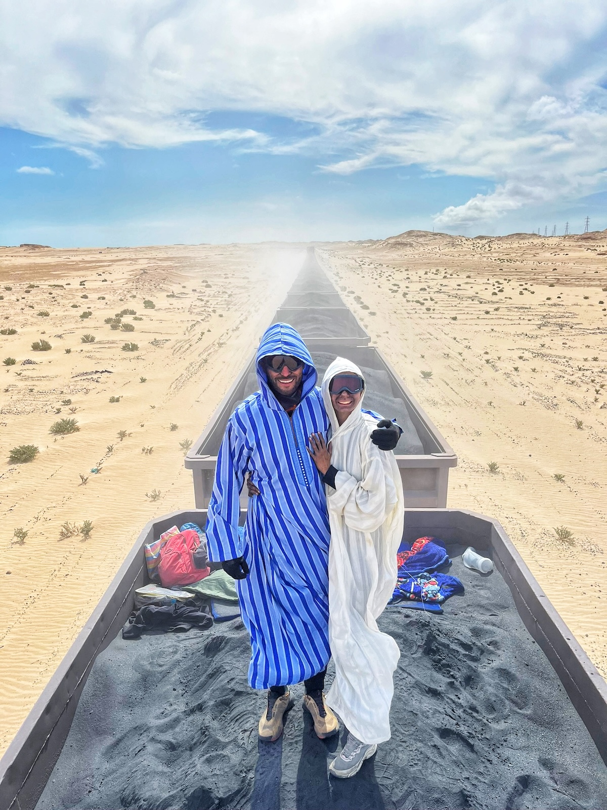 Riding The Iron Ore Train, Mauritania: My Sahara Experience! | couple riding iron ore train Mauritania A couple ride the iron ore train in Mauritania