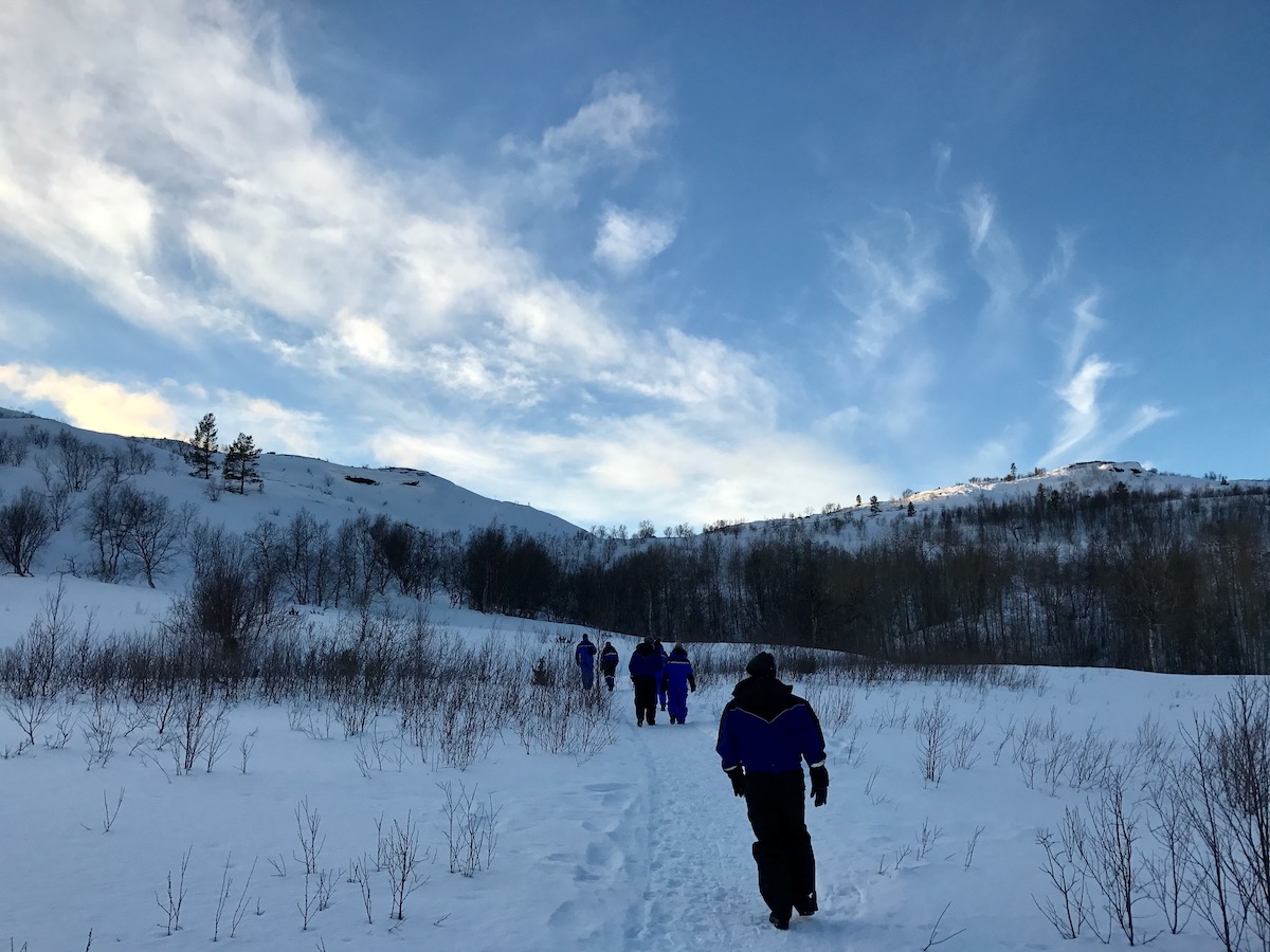 20 Brilliant Things To Do in Kirkenes (+ City Guide!) | daytime in kirkenes People walking through the snowy landscapes of Kirkenes, Norway in the Arctic Circle