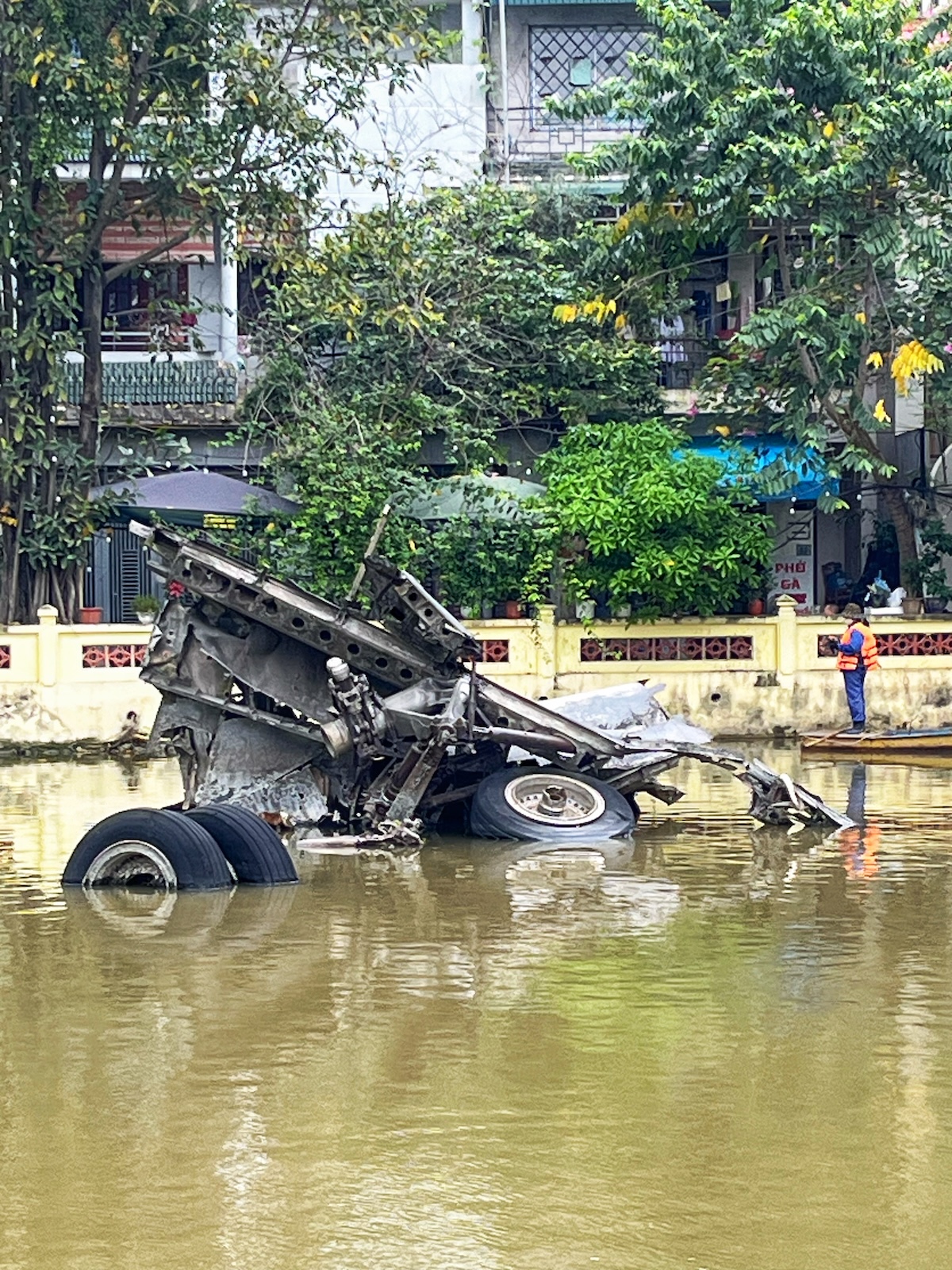 One Day in Hanoi Itinerary: No Transport Needed (Walking Only!) | downed B 52 Hanoi Wreckage of a downed B-52 lies submerged above Huu Tiep Lake River in Hanoi, Vietnam
