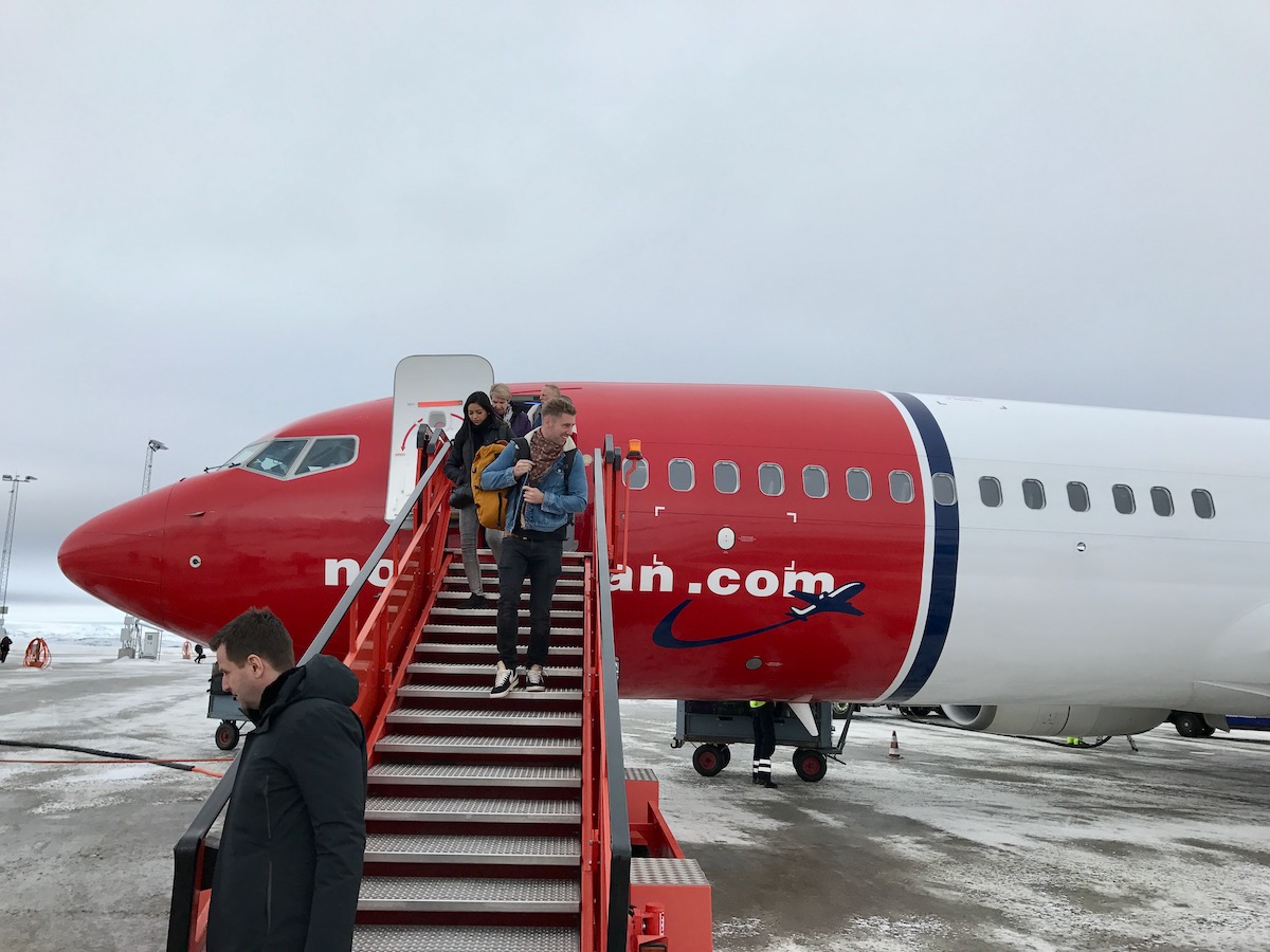 20 Brilliant Things To Do in Kirkenes (+ City Guide!) | flying to kirkenes Tourists smiling as they get off a Norwegian Air flight in Kirkenes, Norway.