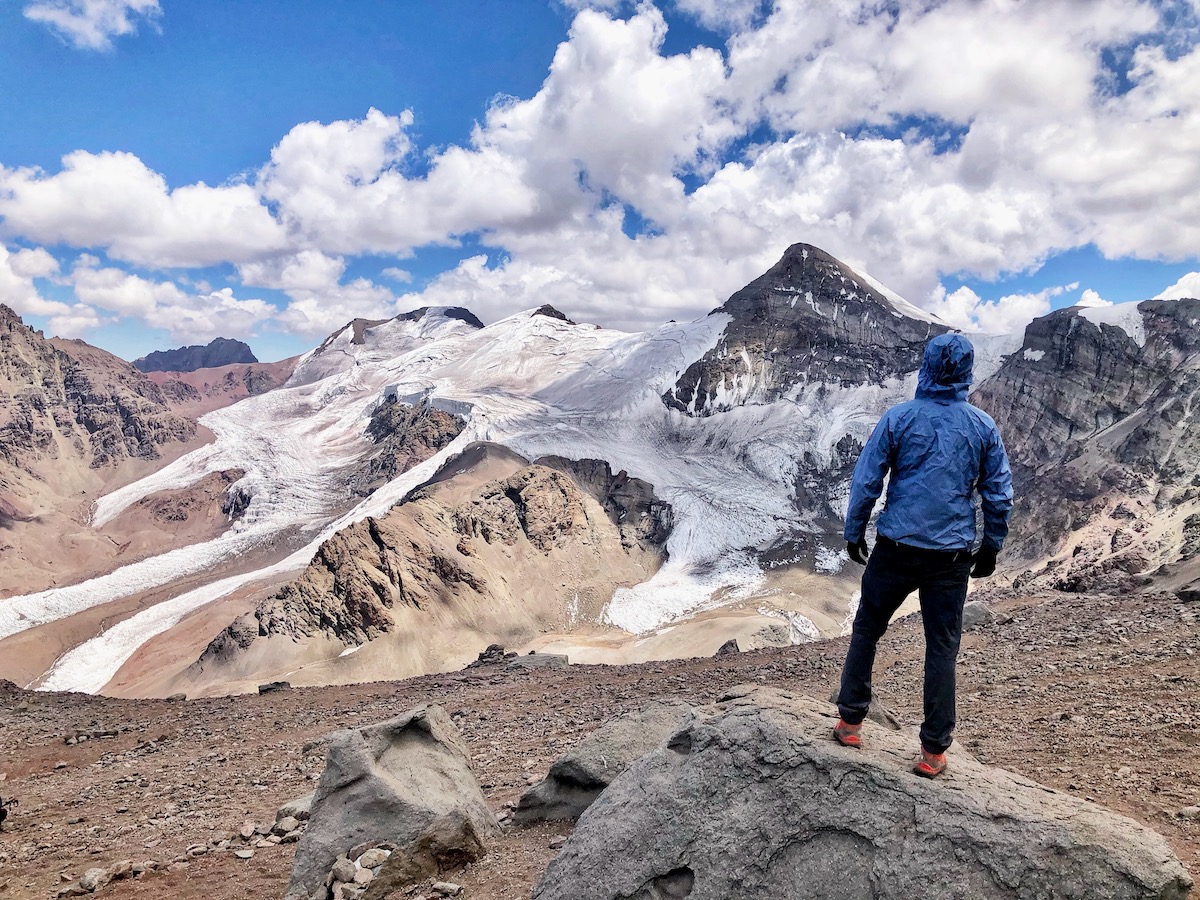 How Hard is it To Climb Aconcagua? | how hard is it to climb Aconcagua 1 A mountain climber in a blue-hooded jacket stares out into the horizon pondering the question' how hard is it to climb Aconcagua?
He is soon to find out.