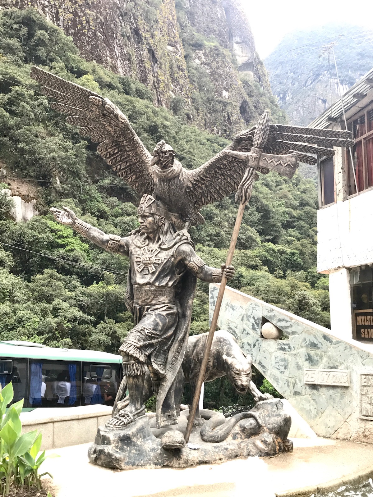 How To Get To Machu Picchu From Cusco (No Dramas, Only Llamas!) | inca warrior statue Aguas Calientes A majestic statue of an Inca warrior with a large bird of prey on his shoulders and. a sphere in his hand in Aguas Calientes, Peru