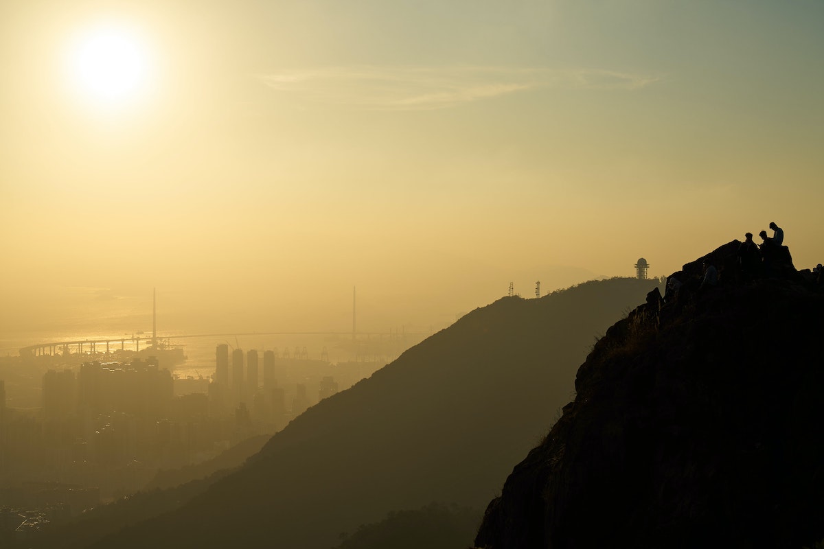 The Ultimate Hong Kong Bucket List: 25 Best Things To Do! | lion rock hong kong A foggy hill overlooking a bridge in Hong Kong.