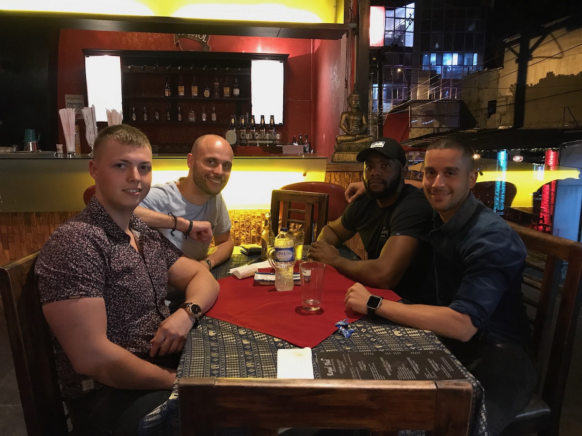 7 Things To Know Before Living in Medellin, Colombia | medellin Men sitting at a table smiling.
