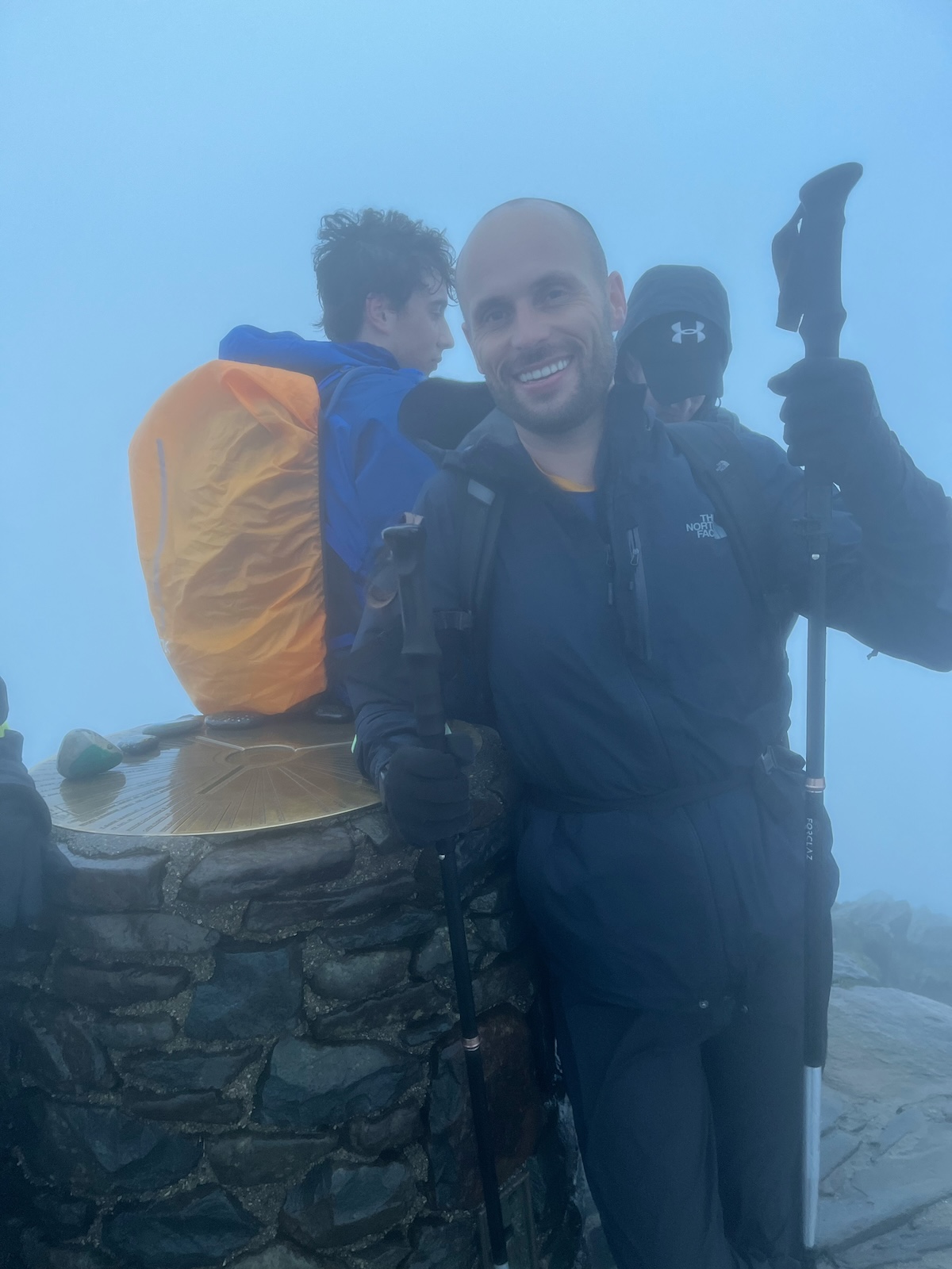 Hiking The UK National 3 Peaks in 24 Hours: An Honest Guide | mount snowdon summit 1 A hiker smiles on top of Mount Snowdon's summit