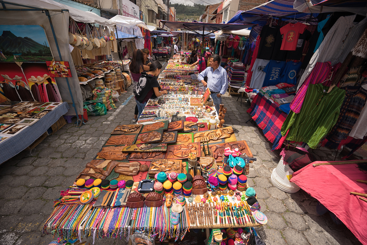 One Week in Quito, Ecuador: 23 Things in 7 Days! | otavalo market indigenous quechua people selling artisan gifts on stands set up on the street in the Saturday market