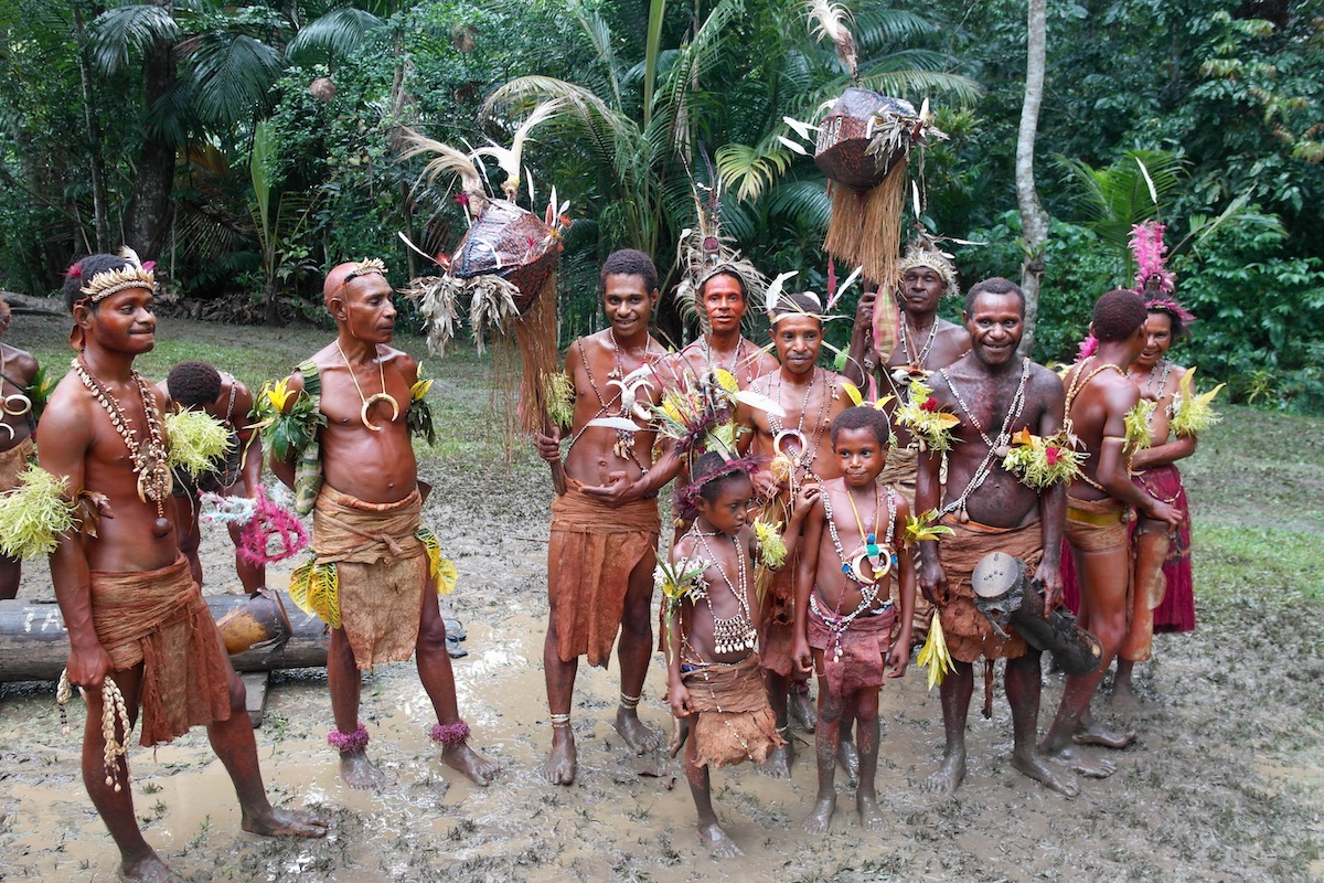 The Tribespeople of Papua New Guinea: A Detailed Guide | papua new guinea tribe Madang A Papua New Guinea tribe adorned in native attire in the muddy rainforest