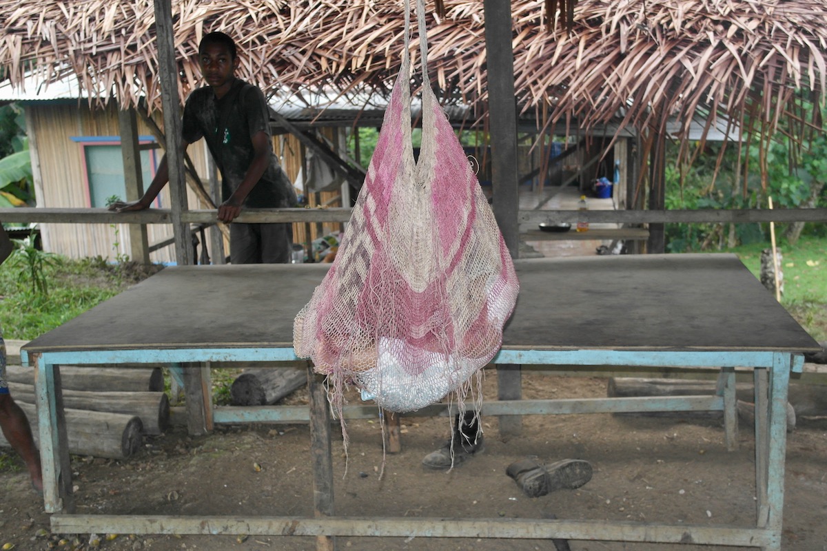 The Tribespeople of Papua New Guinea: A Detailed Guide | papua new guinea tribe baby A baby rests in a hanging bag in the rainforest of Madang, Papua New Guinea