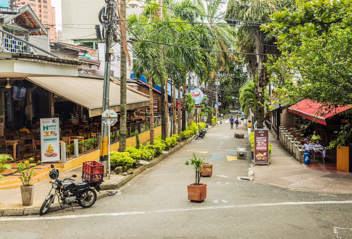 Where To Stay in Medellin: 7 Best Neighbourhoods! | parque lleras medellin A view of some of the bars and restaurants in Lleras Park in Medellin Colombia