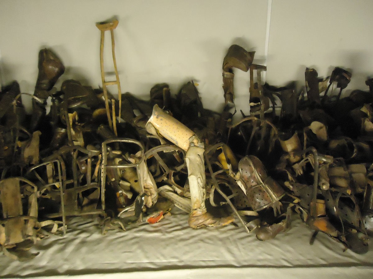 Visiting Auschwitz: All You Need To Know & What To Expect | prosthetic limbs auschwitz museum Prosthetic limbs of the victims of Auschwitz are shown behind a glass at the Auschwitz Museum