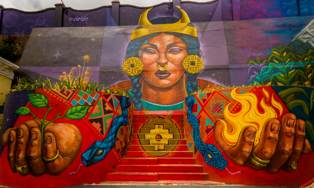 One Week in Quito, Ecuador: 23 Things in 7 Days! | quito street art Street art of a brown lady with fire and growing plants in her hands in Quito, Ecuador.