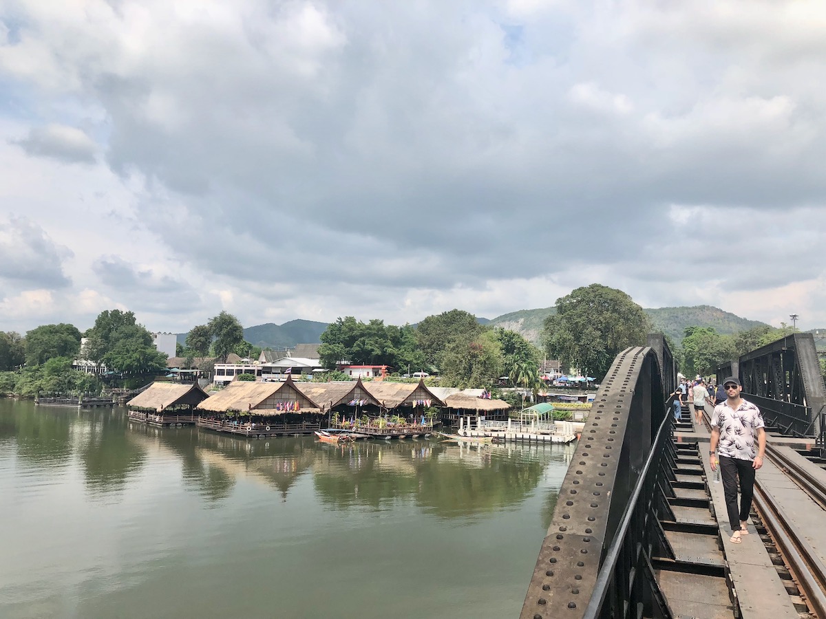 17 Best Thailand Festivals (That You May Never Heard Of) | river kwai bridge thailand A male tourist walks over the River Kwai Bridge in Kanchanaburi, Thailand.