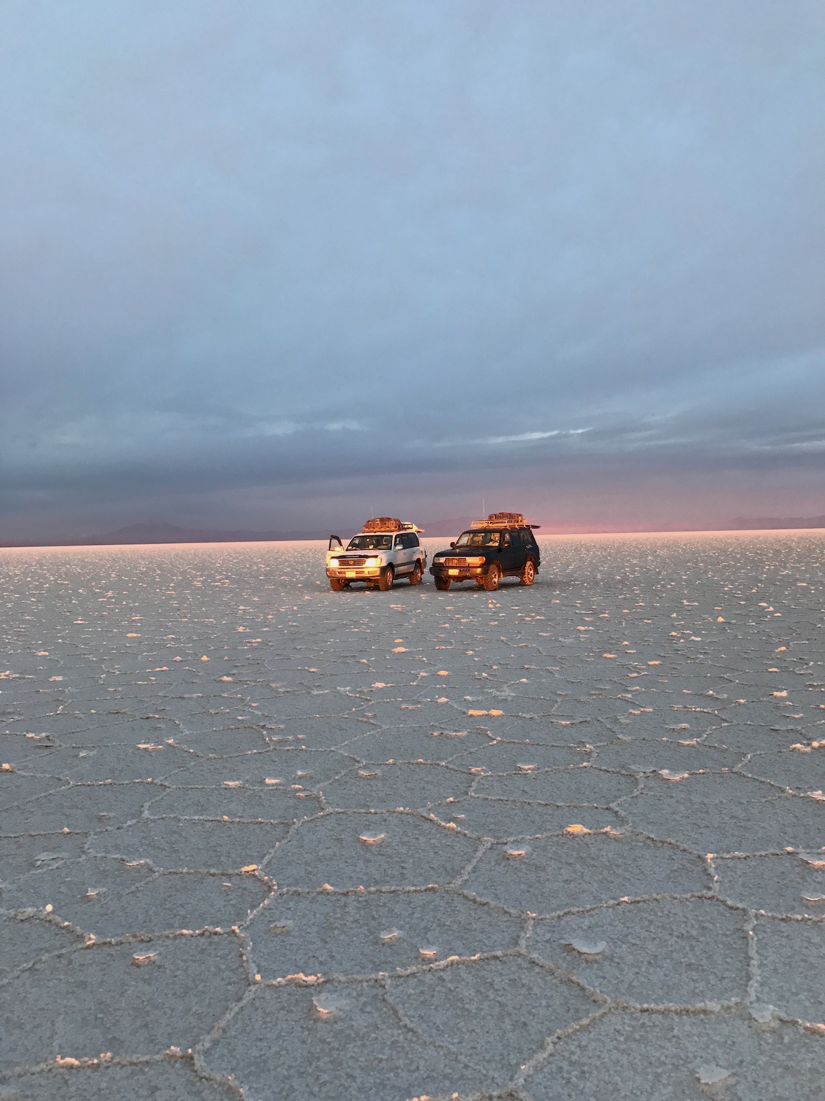Visiting Salar de Uyuni in Bolivia: All You Need To Know | salar de uyuni tour jeeps Two jeeps in the middle of the desert in Salar de Uyuni, Bolivia.