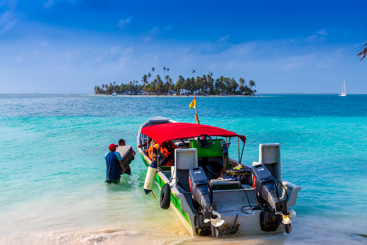 San Blas Islands Travel Guide: Best Things To Do & Logistics | san blas islands water Locals stock up a small water taxi in the San Blas Islands of Panama.