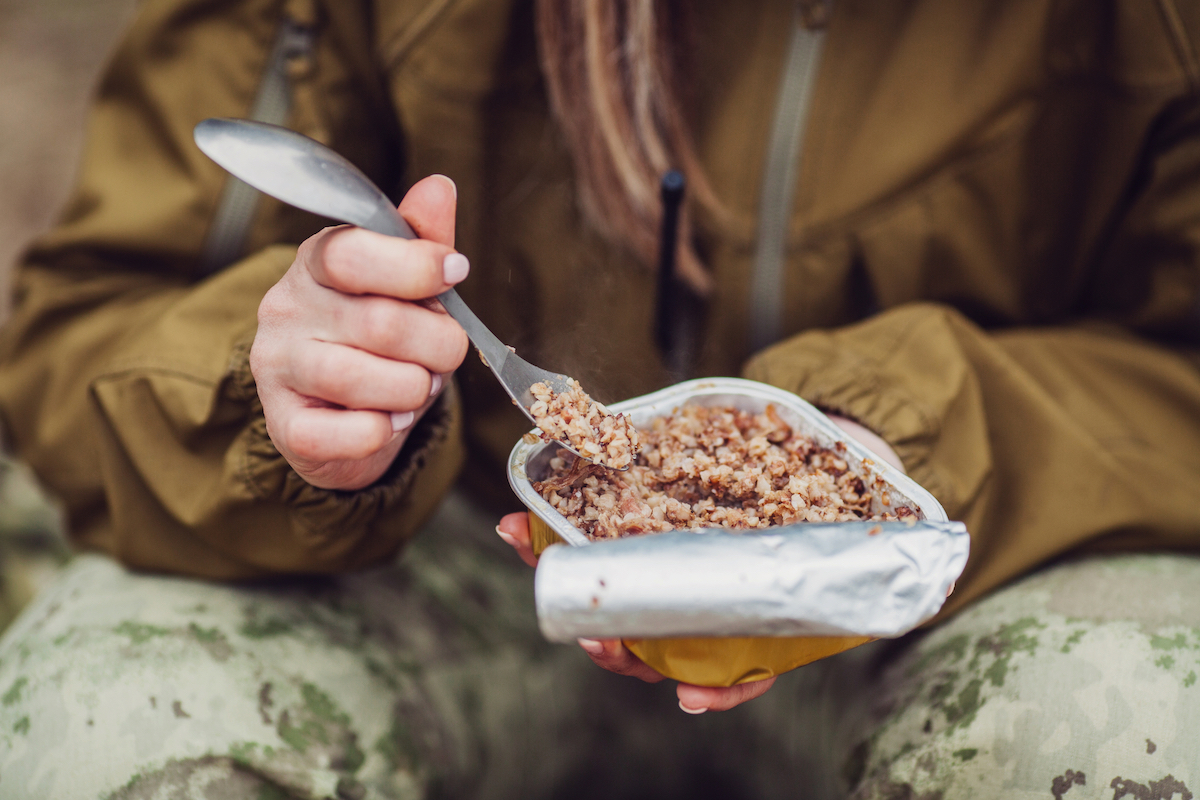 The Only Road Trip Packing List You'll Ever Need! | spork camping A camper eating food with a spork