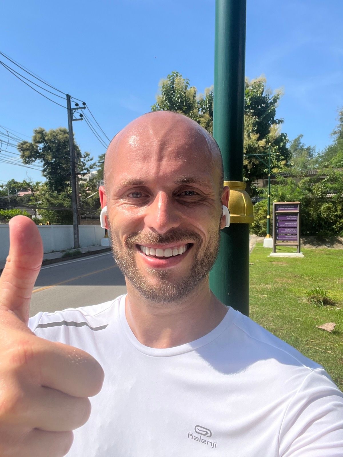 I Went Running 5K Every Day For 30 Days: Insights & Outcomes | thumbs up running 5k everyday Man in white t-shirt puts the thumbs up as he begins to run 5k every day