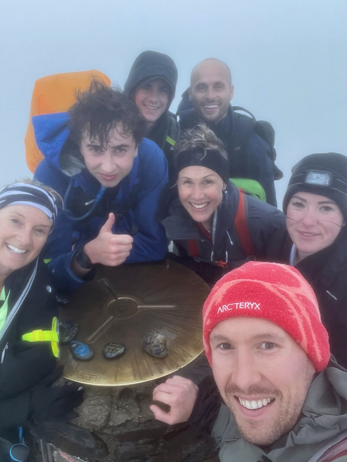 Hiking The UK National 3 Peaks in 24 Hours: An Honest Guide | top of Mount Snowdon Hikers smile at the top of Mount Snowdon, Wales
